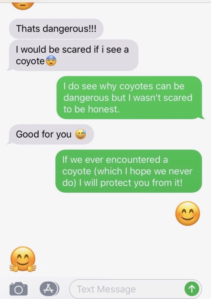 The photo shows a playful and protective text exchange, demonstrating "how to flirt with a girl over text." One person mentions being scared of coyotes, and the other reassures them by saying they would protect them if they ever encountered one, creating a sweet and flirty interaction.