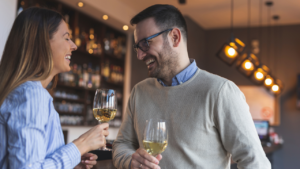 This image shows two people enjoying a lighthearted moment over drinks, both smiling and clearly engaged. It’s perfect for illustrating what to ask a girl you like, as it captures the kind of relaxed, friendly atmosphere where meaningful or flirty questions can help deepen a connection.