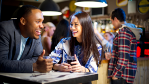 This photo shows a fun, relaxed date conversation. If you're wondering what to ask a girl on a date, try open-ended questions about her interests or favorite travel spots. Keeping things natural and engaging helps create a great connection.