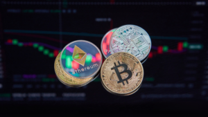 This image features a few well-known cryptocurrency coins, like Bitcoin and Ethereum, in front of a blurred financial chart. It suggests a focus on digital currencies and their value fluctuations. If you're asking, "How Do You Verify a Scammer?", in the crypto world, it's crucial to check for reliable sources, look into transaction histories, and confirm the legitimacy of platforms before making investments. Scammers often use buzzwords like Bitcoin to lure people, but verifying claims against actual data and trusted exchanges is key.