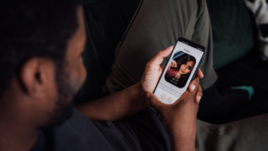 This image shows someone using a dating app, browsing a match's profile. In online dating, knowing "how to know if someone is a scammer" is key. Watch out for signs like avoiding video calls, quickly asking for money, or refusing to meet in person after chatting for a while.