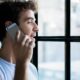 This image shows a young man on the phone, possibly engaged in a conversation. It highlights a common scenario where scammers might try to gain trust over a call. To know if someone is a scammer, be wary of unexpected phone calls where the person pressures you into quick decisions or asks for personal details like bank information.