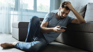 The photo shows a frustrated man sitting alone and might be wondering what to do when you feel like giving up on dating. 