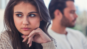 The photo shows the tension and uncertainty of a difficult moment, resonating with the question: "How do you know when to give up on a date?" The contrasting body language between the two individuals hints at the emotional struggle often felt when deciding whether to continue or end a dating situation.