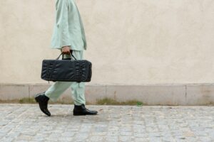 This image highlights a sleek, stylish outfit that demonstrates **how to impress girls by look**. The tailored suit, polished shoes, and fashionable bag showcase confidence and attention to detail—key elements of making a great impression.