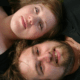 Close-up of a couple lying side by side with contrasting features, representing the theme of do-opposites-attract-in-relationships through visual and emotional connection.
