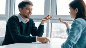 Man and woman engaged in a thoughtful conversation, showing how to ask better questions.