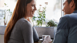 Smiling woman sharing a personal connection during a casual conversation.