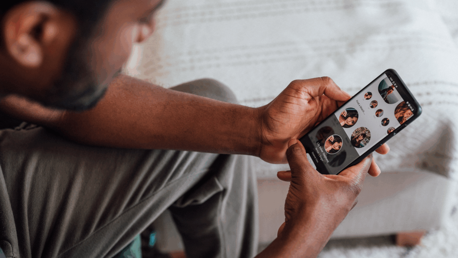 A man browsing a dating app on his phone, illustrating how to avoid dating app burnout by showing the challenge of constant swiping.