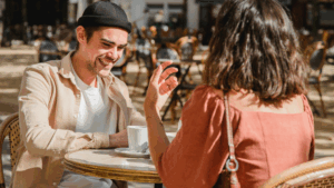 The photo illustrates how to meet women as an introverted person in a relaxed, low-pressure setting like a casual coffee date.