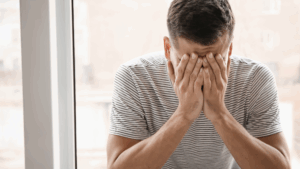 A man showing signs of stress or insecurity.