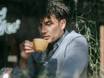 Reflective coffee moment showing how introverted men can have better first dates by leading with calm presence