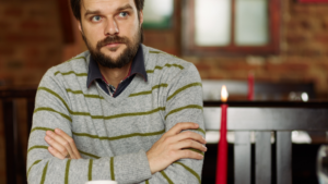 Thoughtful man reflecting on how introverted men can have better first dates by focusing on meaningful connection