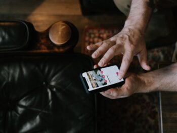 Student man using phone to build a standout online dating profile