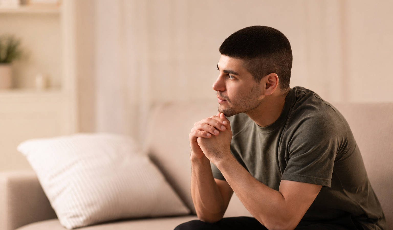 I dating advice — pensive man sitting alone on couch reflecting on his dating life