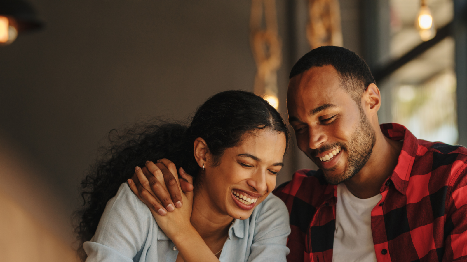 Happy couple laughing together on a genuine date, not a foodie call