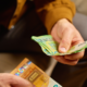 Man counting euro bills to pay for a date, a common sign of a foodie call