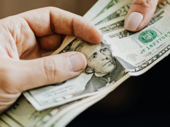 Man handing cash to pay for a date, a common sign of a foodie call